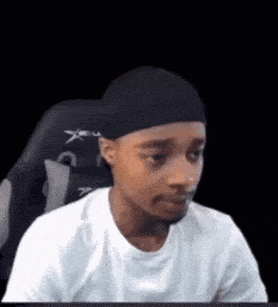 Man In White T-Shirt And Black Hat Sitting GIF