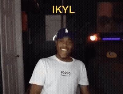 Man In White T-Shirt And Blue Hat Smiling Dancing GIF