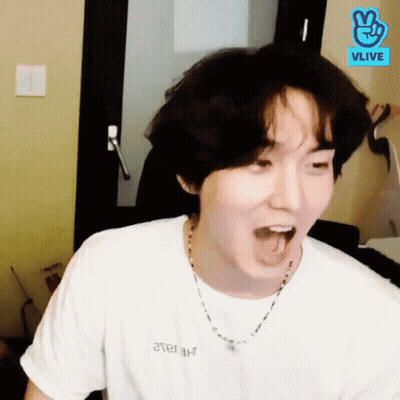 Man In White T-Shirt And Necklace Making Funny Face GIF