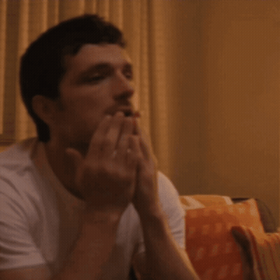 Man In White T-Shirt Holding Head GIF