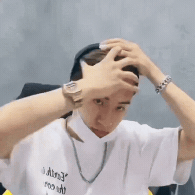 Man In White T-Shirt Holding Head GIF