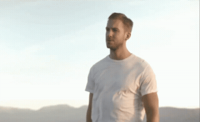 Man In White T-Shirt In Front Of Mountains GIF