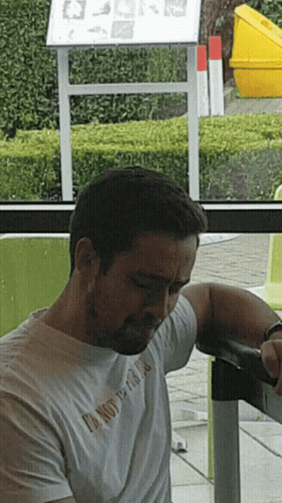 Man In White T-Shirt Saying I'm Not A Fan At Table GIF
