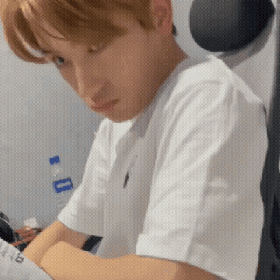Man In White T-Shirt Sitting At Desk With Water Bottle GIF