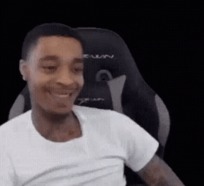 Man In White T-Shirt Smiling In Gaming Chair GIF