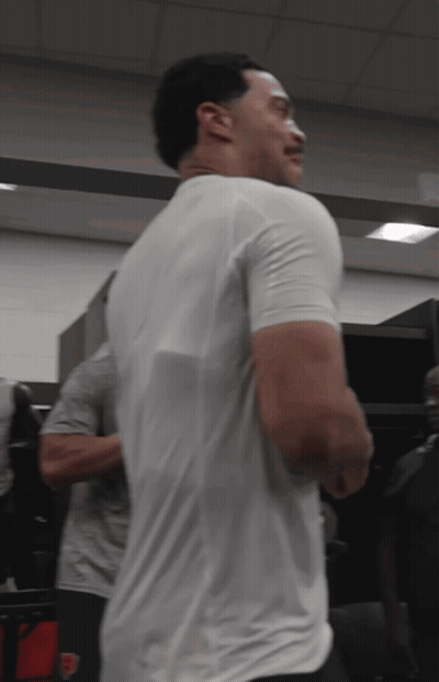 Man In White T-Shirt Standing In Locker Room GIF