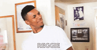 Man In White T-Shirt Standing In Room With Picture GIF