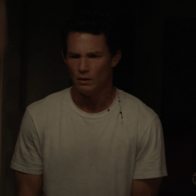 Man In White T-Shirt With Bloody Spot On Chest GIF