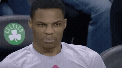 Man In White T-Shirt With Green Shamrock Sitting In Stands GIF