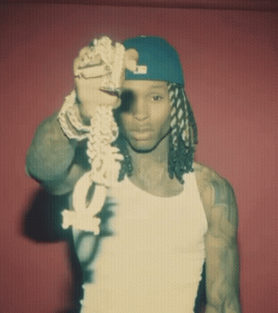 Man In White Tank Top And Blue Hat Holding Chain With Letter O GIF
