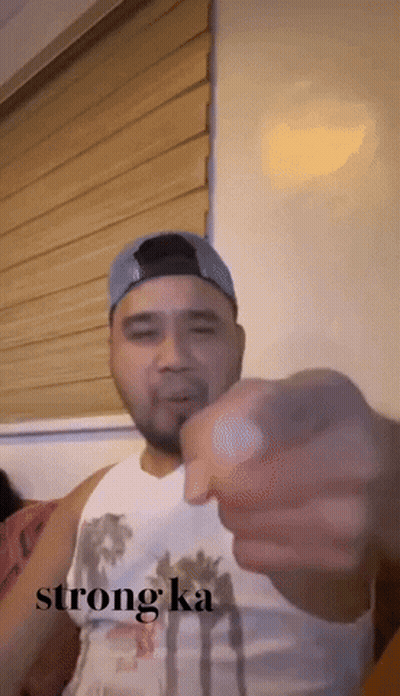Man In White Tank Top And Blue Hat Pointing Saying Strong Ka GIF