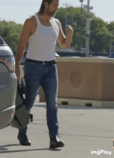 Man In White Tank Top And Blue Jeans Walking GIF
