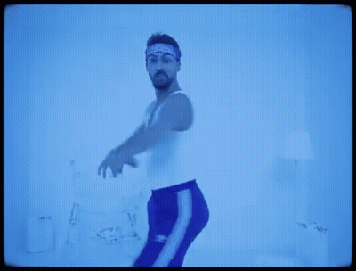 Man In White Tank Top And Blue Pants GIF