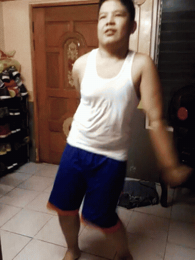 Man In White Tank Top And Blue Shorts Dancing GIF