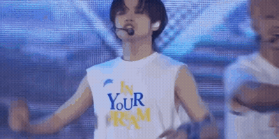 Man In White Tank Top Arms Outstretched On Stage GIF