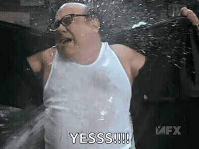 Man In White Tank Top Being Sprayed GIF