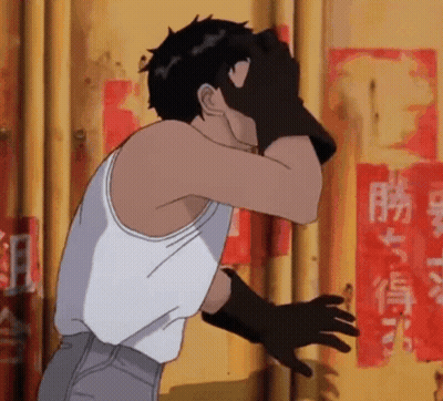 Man In White Tank Top Covering Face With Black Gloves GIF