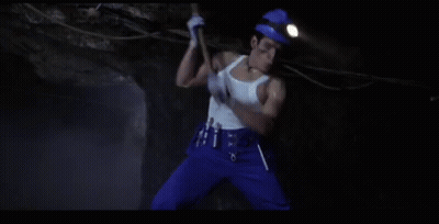 Man In White Tank Top Digging In Cave GIF