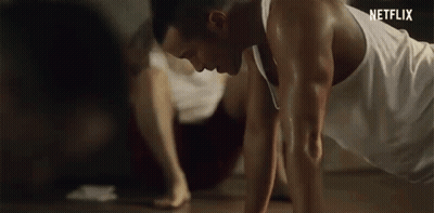 Man In White Tank Top Doing Push-Ups GIF