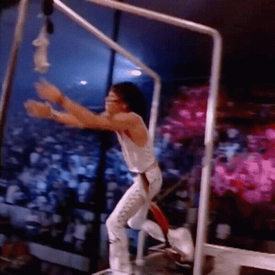 Man In White Tank Top Hanging From Bar GIF