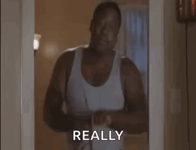 Man In White Tank Top Holding Belt At Doorway GIF
