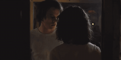 Man In White Tank Top Holding Hair Dryer And Dumbbell GIF