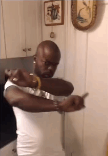 Man In White Tank Top Holding Knife GIF