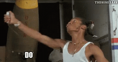 Man In White Tank Top Holding Remote Saying Do GIF