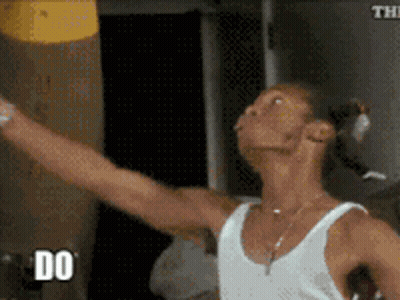 Man In White Tank Top Holding Yellow Object GIF