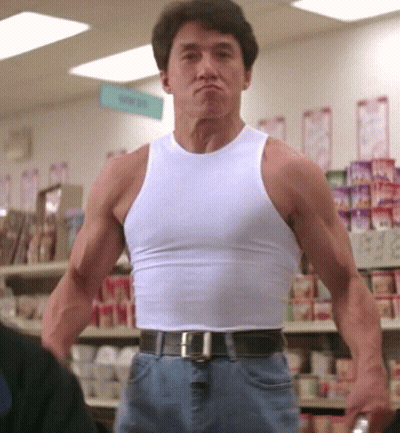 Man In White Tank Top In Front Of Candy Sign GIF