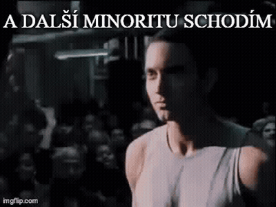 Man In White Tank Top In Front Of Crowd In Dark Room GIF