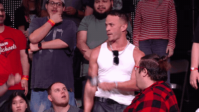 Man In White Tank Top In Front Of Crowd GIF
