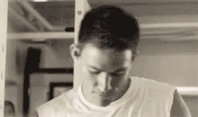 Man In White Tank Top In Gym Mirror GIF