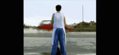 Man In White Tank Top In Parking Lot GIF