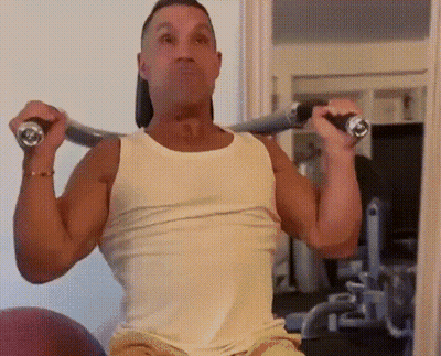 Man In White Tank Top Lifting Barbell Overhead GIF