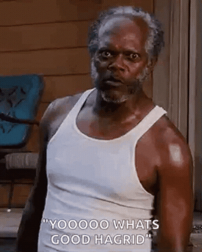 Man In White Tank Top Looking At Camera GIF