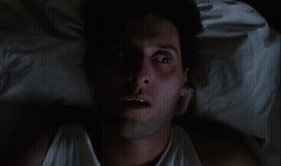 Man In White Tank Top Lying In Bed Eyes Closed GIF