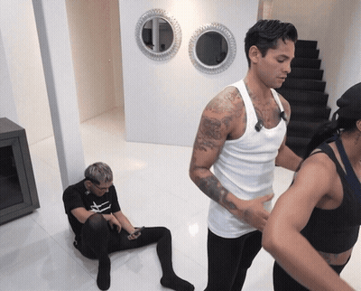 Man In White Tank Top Next To Woman In Black Tank Top GIF
