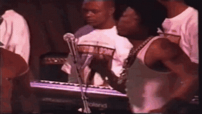 Man In White Tank Top Playing Keyboard For Crowd GIF