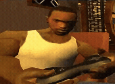 Man In White Tank Top Playing Video Game On Couch GIF