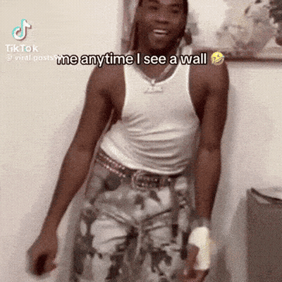 Man In White Tank Top Saying I Mean Anytime I See A Wall GIF
