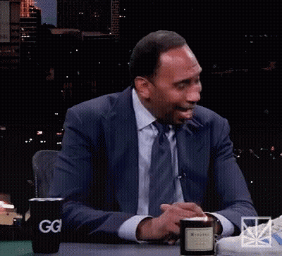 Man In White Tank Top Sitting On Couch GIF