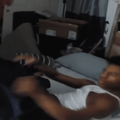 Man In White Tank Top Sitting On Couch GIF