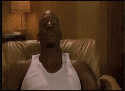 Man In White Tank Top Sitting On Couch GIF
