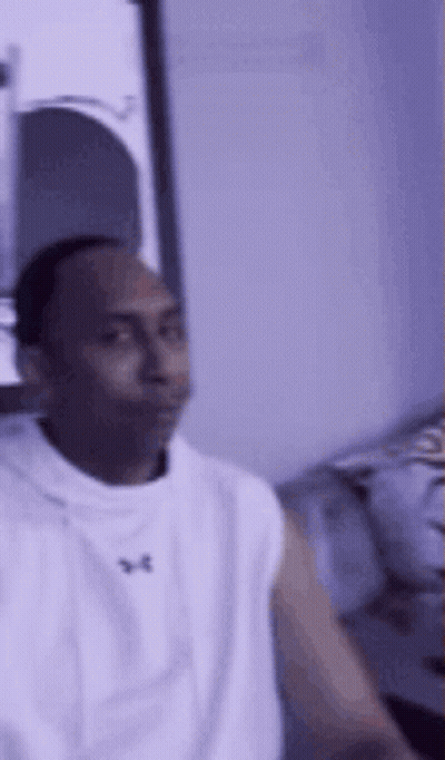 Man In White Tank Top Sitting On Couch GIF