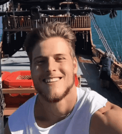 Man In White Tank Top Smiling On Boat GIF