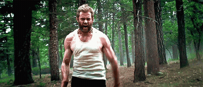 Man In White Tank Top Standing In Forest GIF
