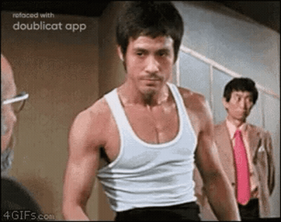 Man In White Tank Top Standing Next To Man In Suit And Tie GIF
