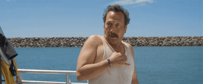 Man In White Tank Top Standing On Boat GIF