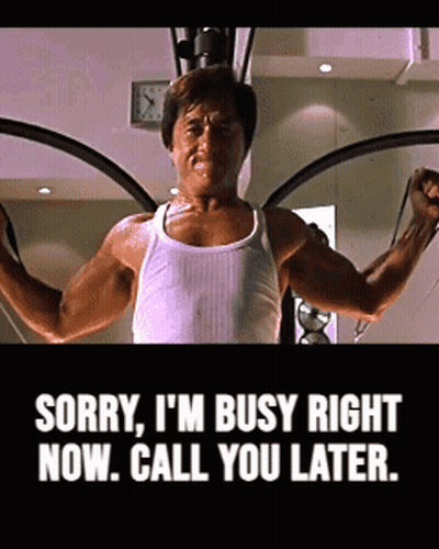 Man In White Tank Top Using Machine Says Sorry Busy Call You Later GIF